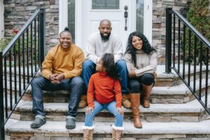 family sat on steps